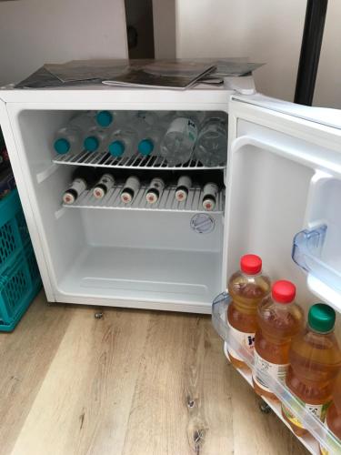 an open refrigerator filled with bottles of water at Loreley bed and breakfast in Bornich