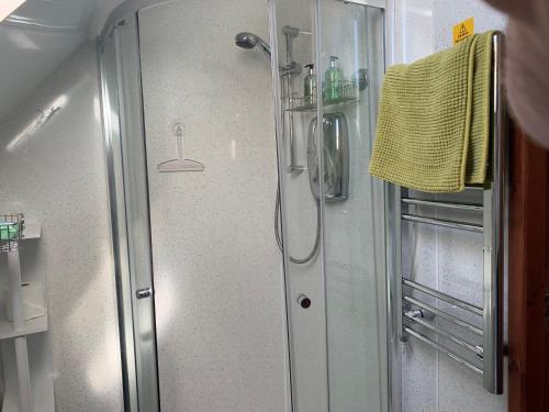 a shower with a glass door in a bathroom at Tors Place in Portree