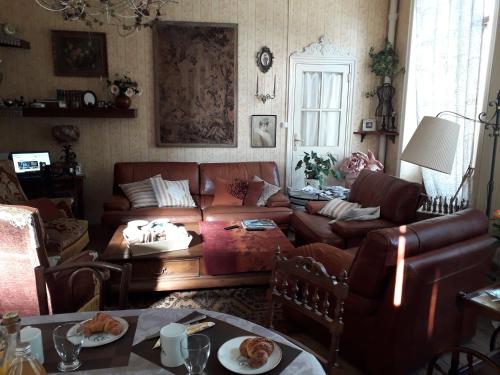 a living room with a couch and a table at la Ganse Blanche in Usson-en-Forez