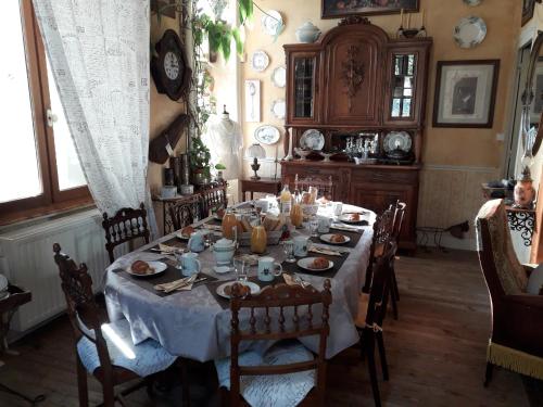 a dining room with a table with food on it at la Ganse Blanche in Usson-en-Forez