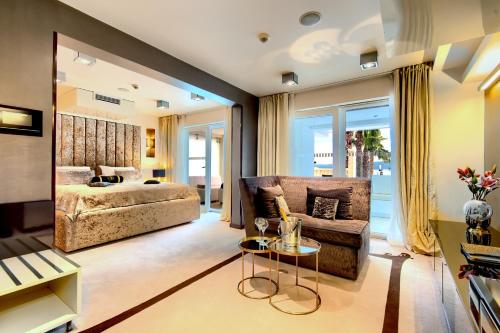 a living room with a couch and a bed at Damianii Luxury Boutique Hotel & Spa in Omiš
