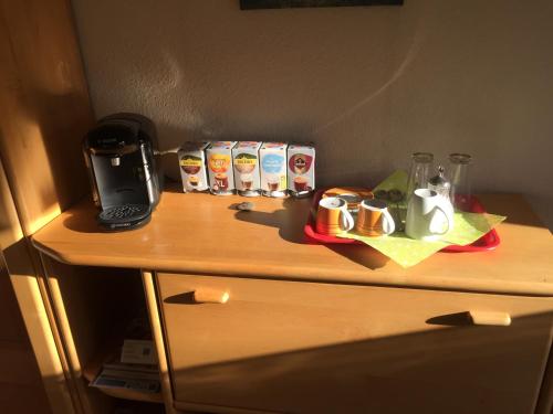 a table with a coffee maker and cups on it at Chill out 2 in Sulzbach am Main