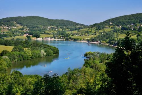 a river with boats on it in a valley at Glamping Lac du Causse in Lissac-sur-Couze