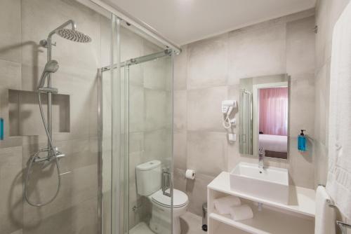 a bathroom with a shower and a toilet and a sink at Lisbon Serviced Apartments - Campos in Lisbon