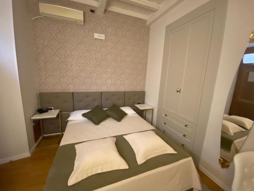 a hotel room with a bed and a desk at Rhona's Rooms in Rome