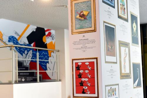 a wall with paintings and pictures on it at HI Braga - Pousada de Juventude in Braga