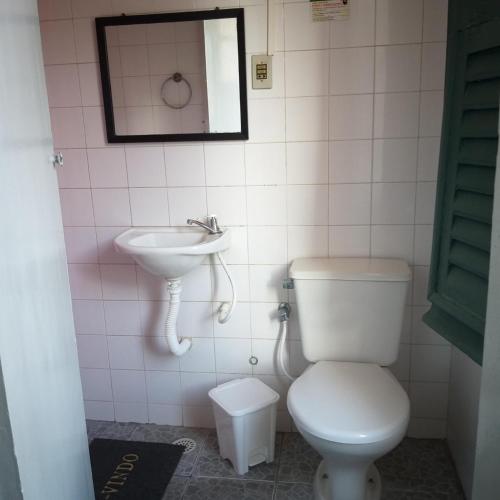 a bathroom with a toilet and a sink at Hotel Central in Recife