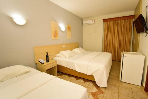 En eller flere senge i et værelse på Hotel Villa Santo Agostinho