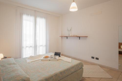 a bedroom with a bed with a tray of food on it at Residence Le Fontane in Villasimius