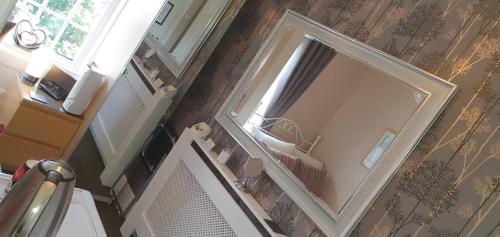 an overhead view of a bathroom with a large mirror at Beechwood Guest House in South Shields