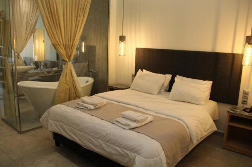 A bed or beds in a room at Alexiou Hotel