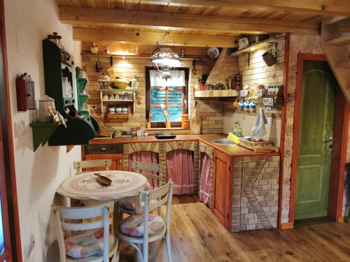 a kitchen with a table and chairs in a room at Brvnara na obali reke Drine in Beserovina