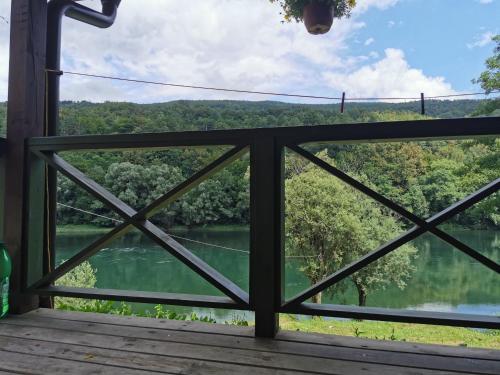 a view from a screened in porch with a view of a river at Brvnara na obali reke Drine in Beserovina