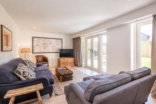 a living room with a couch and a tv at Owl Cottage in Wighton