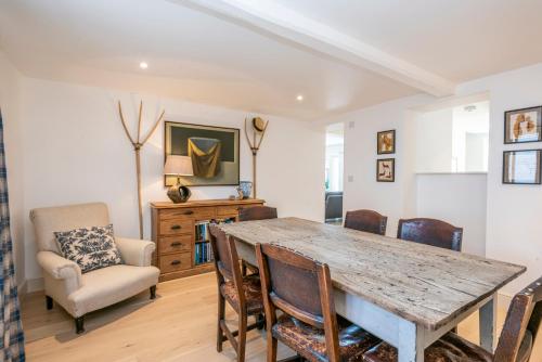 a dining room with a wooden table and chairs at Owl Cottage in Wighton