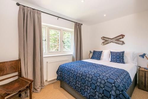 a bedroom with a bed and a cross on the wall at Owl Cottage in Wighton