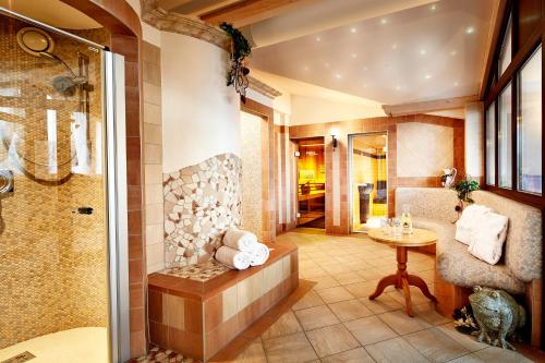 a bathroom with a shower and a table at Hotel Flatscher in Stuhlfelden