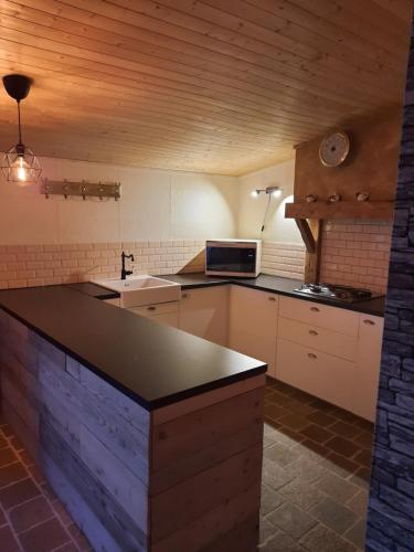 a kitchen with a counter top in a room at Al'fagne de boca in Bertogne