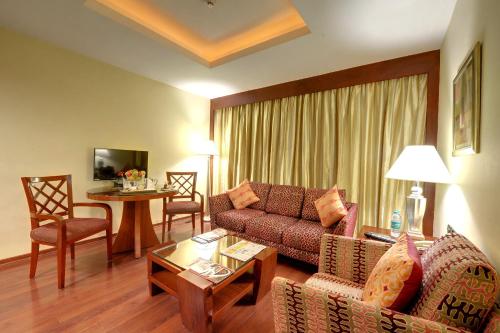 a living room with a couch and a table at Fortune Select JP Cosmos, Bengaluru - Member ITC Hotels' Group in Bengaluru
