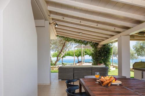 an outdoor dining area with a wooden table and chairs at TheTree Villa, Magical Scenery Experience, By ThinkVilla in Gállos