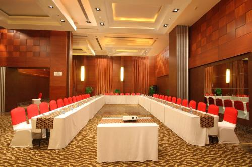 a large conference room with tables and red chairs at Fortune Select JP Cosmos, Bengaluru - Member ITC Hotels' Group in Bengaluru