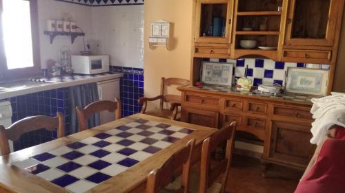 a kitchen with a table and a checkered floor at CASONA de los Peregrinos I in Cepeda