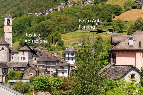 a small village with houses and a church at Rustico Luchessa Valle Verzasca in Lavertezzo