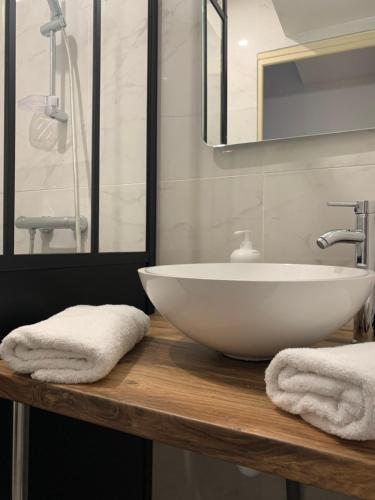 a bathroom with a white sink and a mirror at Sweet Discovery & Jungle in Bourges