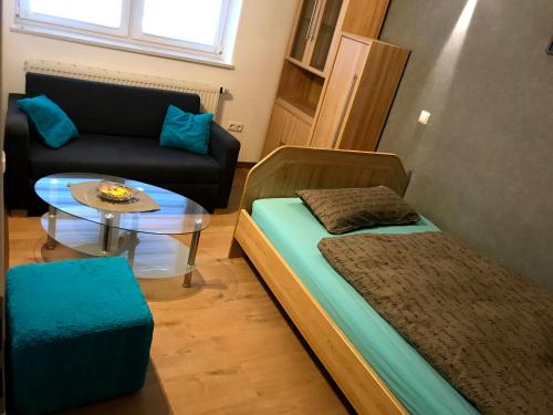 a small room with a bed and a coffee table at Chill Out 1 in Sulzbach am Main