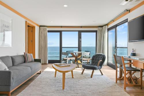 a living room with a couch and a table at SA Carbon Beach Suites in Malibu