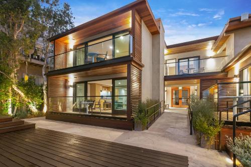 a large house with a deck in front of it at SA Carbon Beach Suites in Malibu
