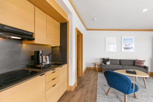 a kitchen and living room with a couch and a table at SA Carbon Beach Suites in Malibu