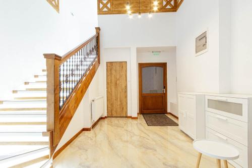a room with a staircase and a stair case at Buchenland Hotel in Câmpulung Moldovenesc