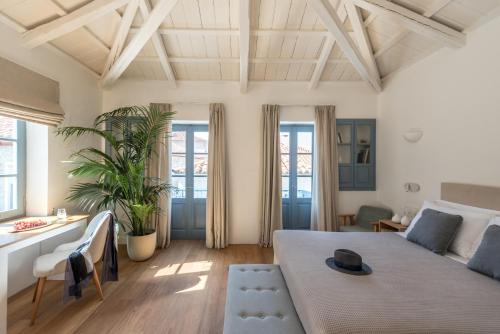 a living room with a large bed and a couch at NESEA Boutique Apartments in Hydra