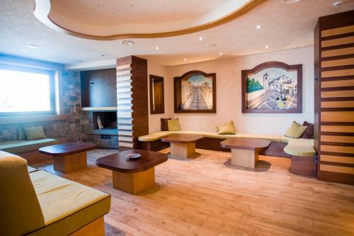 a living room with two tables and a couch at Hotel Monte Campo in Capracotta