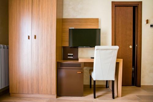 a room with a desk with a computer and a white chair at Hotel Monte Campo in Capracotta