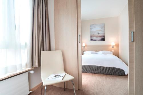 Ένα ή περισσότερα κρεβάτια σε δωμάτιο στο Starling Hôtel Résidence Genève