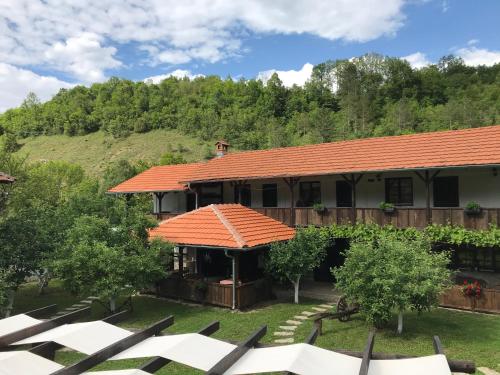 a house with an orange roof on a yard at Konak Tosa in Poganovo
