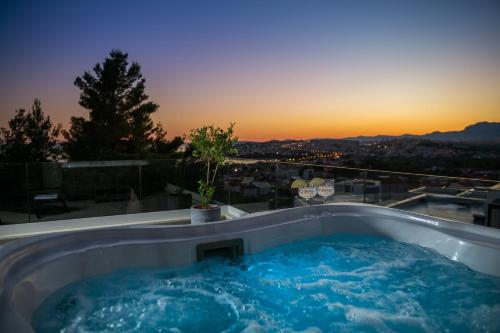 a jacuzzi tub with the sunset in the background at Villa 9 in Podstrana