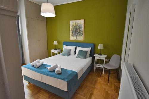 a bedroom with a bed and a green wall at Check Point - Koukaki in Athens