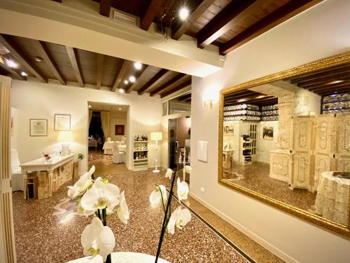 a living room with a large mirror on the wall at Albergo Gardesana in Torri del Benaco