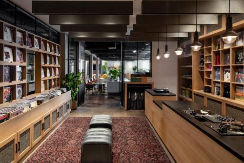 a library with a bench in the middle of a room at Vignette Collection Yours Truly DC by IHG in Washington