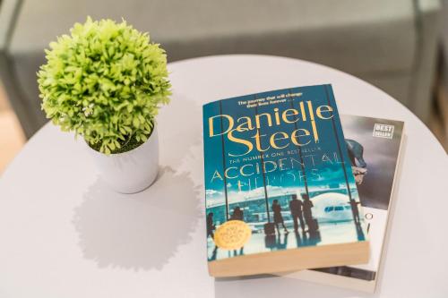 a book sitting on a table next to a plant at Art Hotel Dubrovnik in Dubrovnik