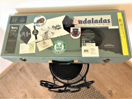 a suitcase with stickers on it sitting on a floor at Apartamento T1 no centro TÊ-U in Torres Vedras