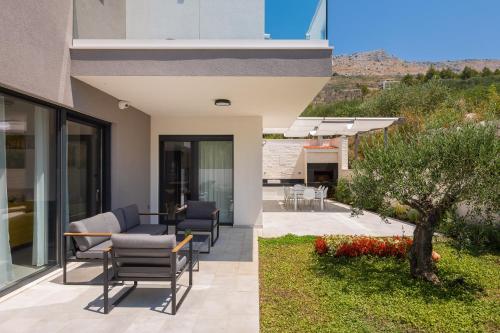 two views of a house with a patio at Villa 9 in Podstrana