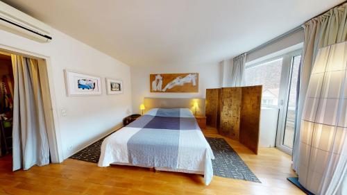 a bedroom with a bed and a large window at Amazing View_Loft Apartment in the heart of Vienna in Vienna