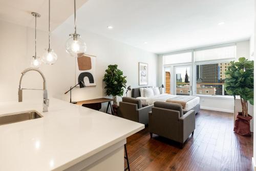 a kitchen and living room with a couch and a table at Kislak 603 1BR Penthouse with Stunning Rooftop Terrace in Newark