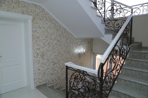 a staircase in a home with a wrought iron railing at METROPOLIS in Ulcinj
