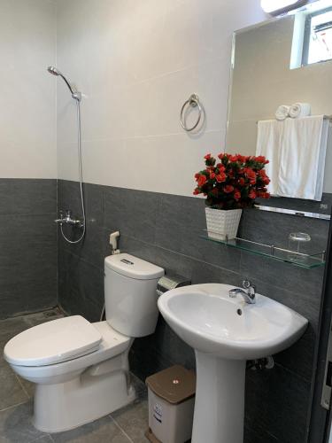a bathroom with a toilet and a sink at Rang Dong Hue Hotel in Hue