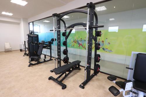 a gym with several tread machines in a room at Hotel Kanade Kanku Kaizuka in Kaizuka